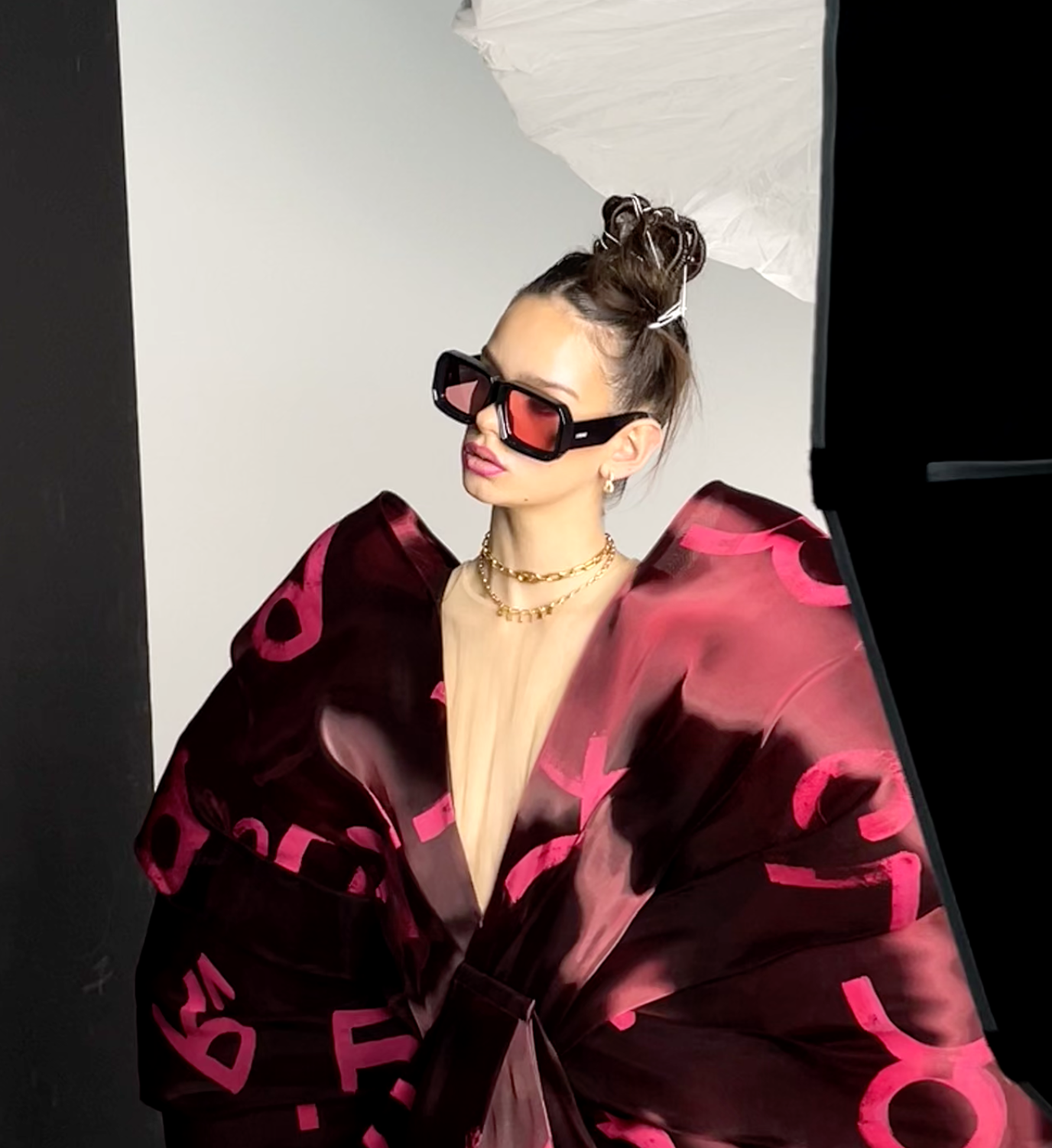Behind the scenes still of a burgundy editorial look
