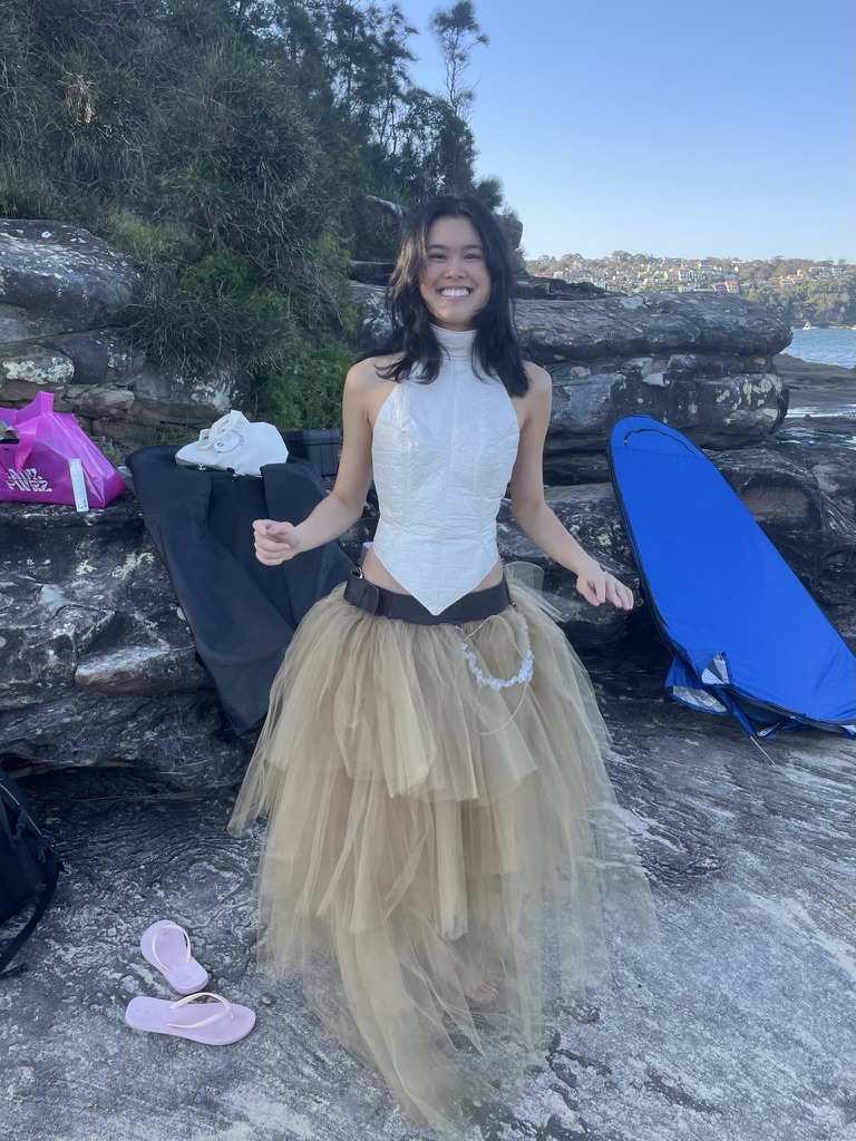 Behind the scenes on a coastal rocks shoot in a tulle skirt