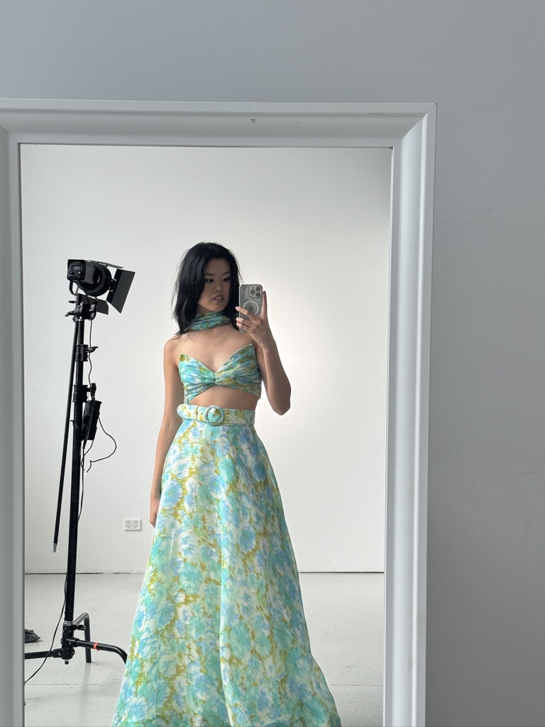Mirror portrait in a blue floral gown on set